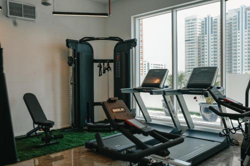 a gym with two tread machines and a window at Shada Hotel - فندق شدا in Dubai