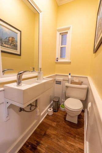 a bathroom with a white sink and a toilet at Cardinal Inn Boho Room in Cornwall