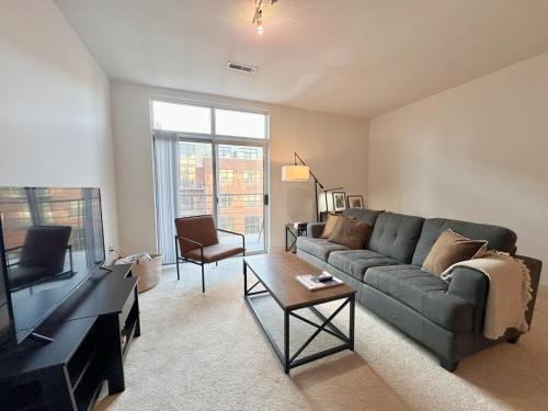 a living room with a couch and a tv at Flexhome Third Ward 1BR J2 with Gym and Balcony - READ INFO in Milwaukee