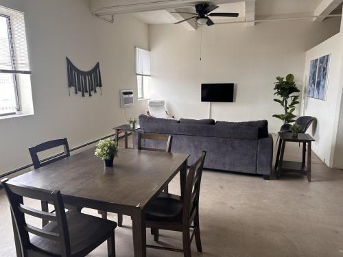 a living room with a table and a couch at Flexhome Westown 1BR RS2 near Fiserv and Theater District - READ INFO in Milwaukee