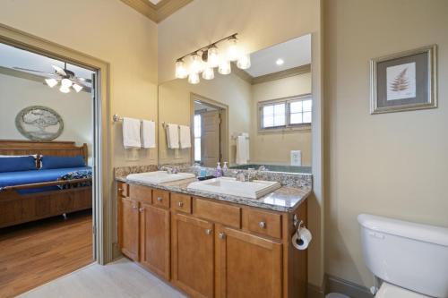 a bathroom with two sinks and a large mirror at The Laurel Ridge Den in Big Canoe with hot tub in Marblehill