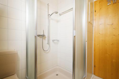 a bathroom with a shower and a bath tub at Apartment Brugg in Amden