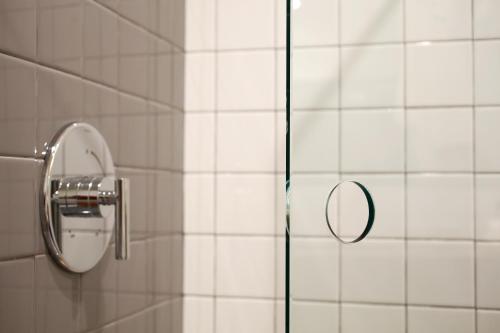 a shower with a mirror in a bathroom at The Durham Hotel in Durham