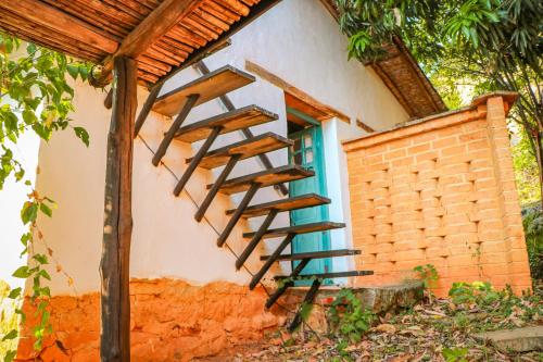 a wooden staircase on the side of a building at Hotel Spa El Cogollo By MH in Barichara