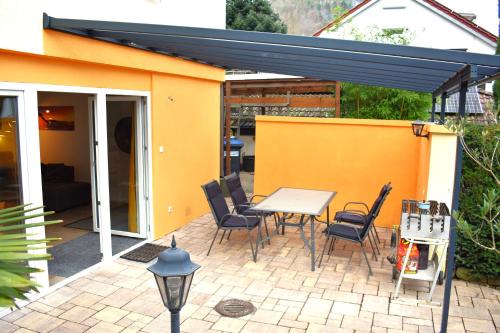 a patio with a table and chairs and a building at FVH Family Vacation Heidelberg in Heidelberg