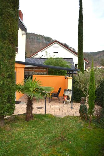 a house with a patio with a table and a chair at FVH Family Vacation Heidelberg in Heidelberg
