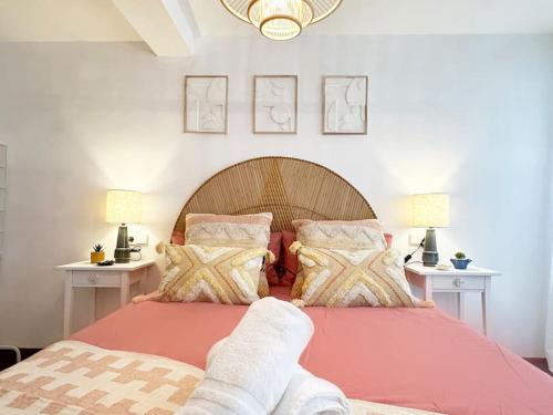 a bedroom with a red bed with two white tables at Apartamento de diseño en el puerto de Castro in Castro-Urdiales