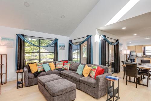 a living room with a couch and a table at West Palm Beach Lake House Near Beaches! in West Palm Beach