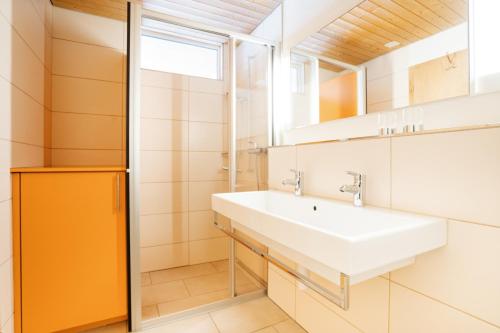a bathroom with a sink and a mirror at Apartment Bischofberger D20 in Amden