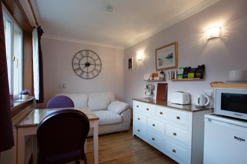 a living room with a couch and a table at Taigh Toilichte in Fort William