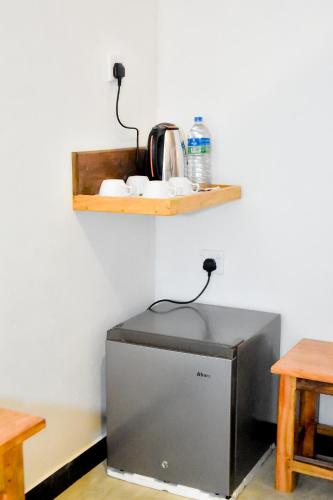 a microwave sitting on a counter in a room at Wild River Side in Udawalawe