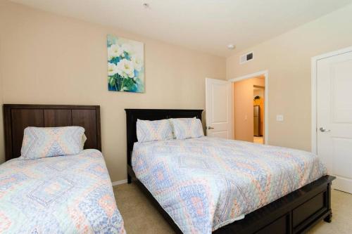 a bedroom with two beds and a painting on the wall at Huge 2bd Apt Near Disneyland & Anaheim Conv Centr in Orange