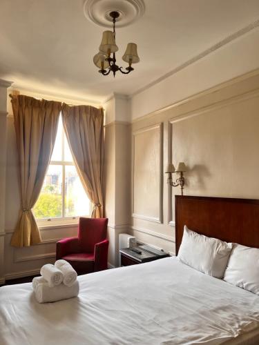 a bedroom with a bed and a chair and a window at Beech Mount Hotel - Free Parking in Liverpool