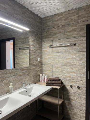 a bathroom with a sink and a mirror at Haus Kärnten in Döbriach