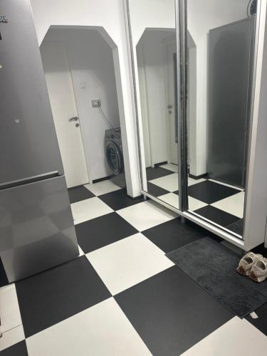 a bathroom with a black and white checkered floor at Apartament Sorin in Tulcea