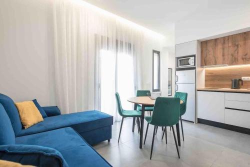 a living room with a blue couch and a table at Cozy apartment in a new building apartment 2 in Piraeus