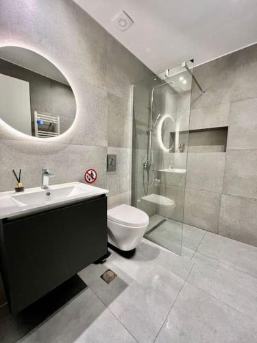 a bathroom with a sink and a toilet and a shower at Cozy apartment in a new building apartment 2 in Piraeus