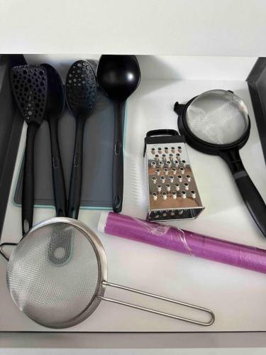 a group of kitchen utensils sitting on a counter at Cozy apartment in a new building apartment 2 in Piraeus
