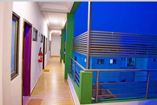 a hallway of a building with blue and green walls at CELEBRITES HOTEL in Ouidah