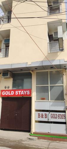a building with a sign that reads cold stays at gold stays hotel near IGI international airport in New Delhi