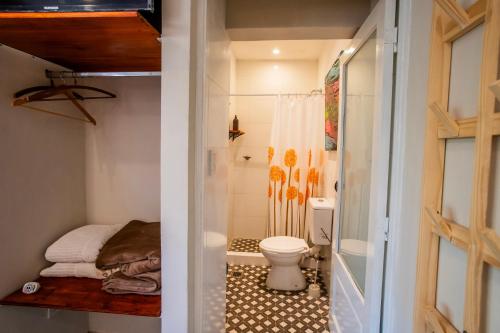 a small bathroom with a toilet and a shower at Casa de Arte CiTá, bed and breakfasts in San Miguel de Tucumán