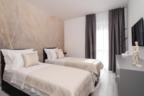 En eller flere senge i et værelse på Luxury Villa Entrata