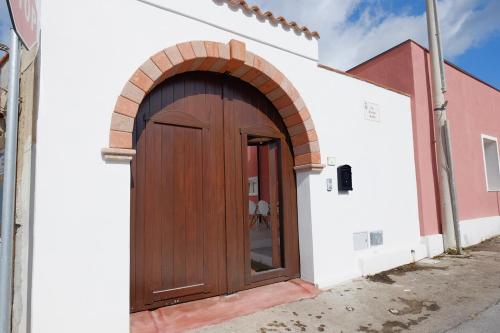 a wooden door on the side of a building at Newly built Holiday House in Teulada in Teulada