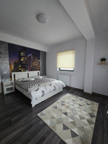 a bedroom with a large bed and a window at DD Residence in Otopeni