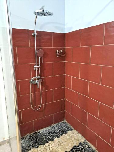 a bathroom with a shower with red tiles at Appartement d'une chambre avec wifi a Le Vauclin in Le Vauclin