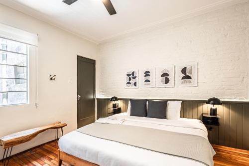 a bedroom with a large white bed and a window at LAREDO By Mr W in Mexico City