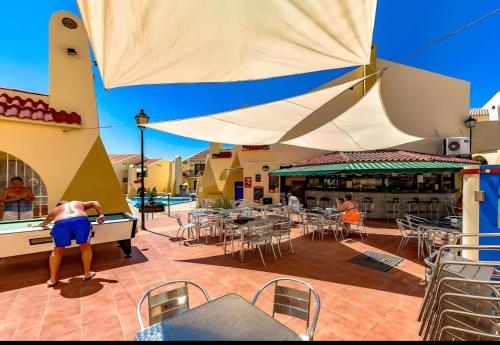 a man playing a game of ping ping pong on a patio at House Harvey J53 Mareverde in Adeje