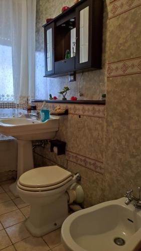 La salle de bains est pourvue de toilettes, d'un lavabo et d'une baignoire. dans l'établissement Casa Amici Miei, à Catane