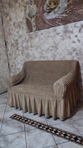 a brown bench sitting on the floor in a room at Casa Amici Miei in Catania