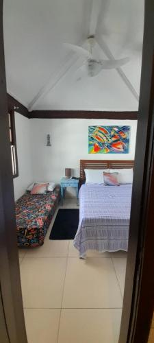 a bedroom with two beds and a ceiling at Hospedagem Tucanos in Búzios