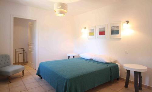 a bedroom with a bed and a table and a chair at Residence Catherine in Calvi