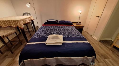 a bedroom with two beds and a table and a table at Spacious Room next to Subway Line 1 Midtown Toronto in Toronto