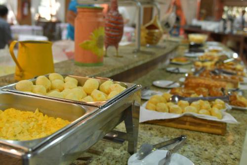 a buffet line with different types of food at Hotel Amoreiras in Extrema
