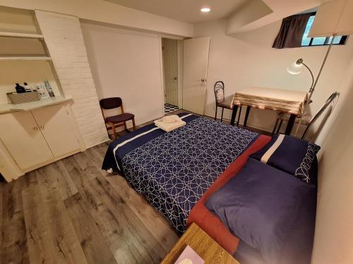 a bedroom with a bed and a table and chairs at Spacious Room next to Subway Line 1 Midtown Toronto in Toronto