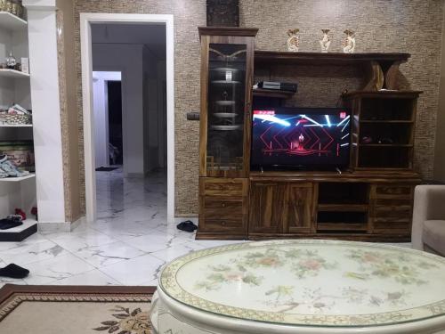 a living room with a tv and a table at My house 1 in Nador