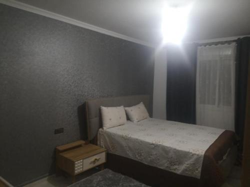a small bedroom with a bed and a window at My house 1 in Nador