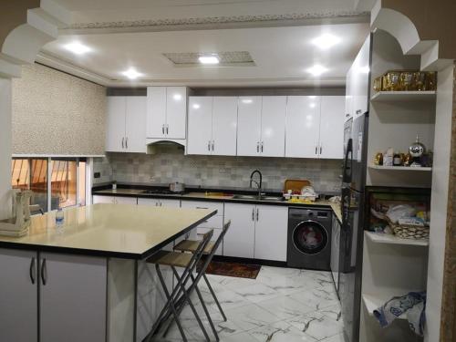 a kitchen with white cabinets and a counter top at My house 1 in Nador