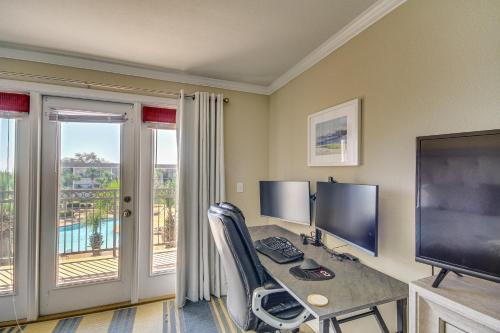 a room with a desk with a computer and a balcony at Biloxi Condo with Pool Access - Steps to Beach! in Biloxi