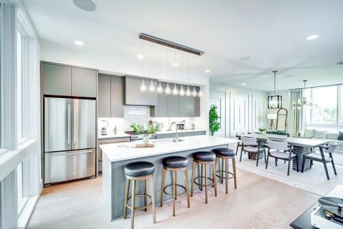 a kitchen with a large island with bar stools at The Duo - 24 Beds & Stunning City Views Rare Find in Nashville
