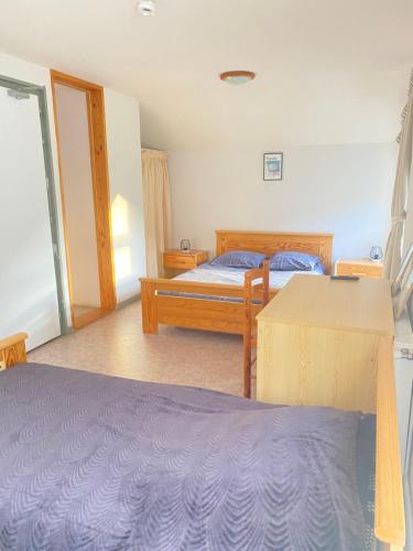 1 dormitorio con 2 camas y mesa en Auberge le bois du cornet, en La Forclaz