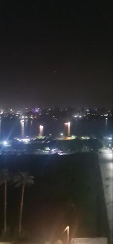 uma vista para uma cidade à noite com luzes em شقه بكورنيش النيل em Al Ma‘şarah