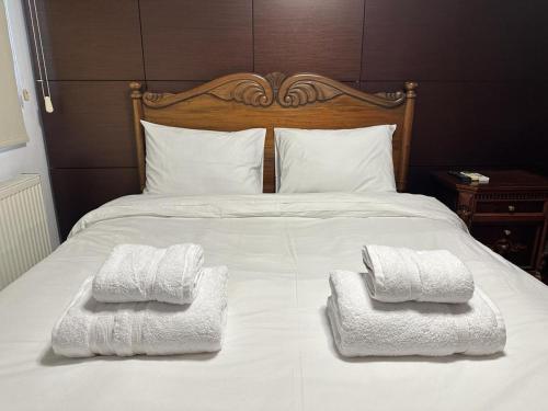 a bed with two towels on top of it at Hill Luxury Family Maisonette 21 in Ayios Dhometios