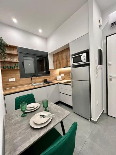 a kitchen with a table and chairs and a kitchen with a sink at Cozy apartment in a new building apartment 3 in Piraeus