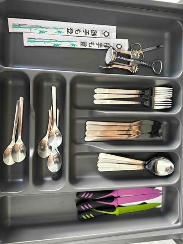 a lunch box with utensils and spoons at Cozy apartment in a new building apartment 3 in Piraeus