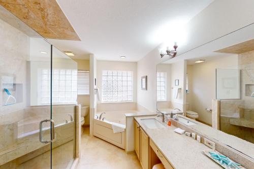 a bathroom with two sinks and a shower at Lantana Bay Escape in South Padre Island