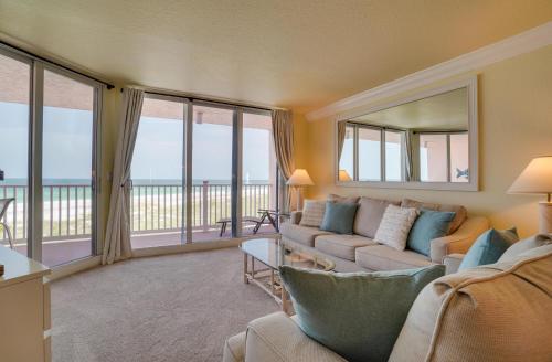 a living room with a couch and views of the ocean at Spectacular Sunsets at this Beachfront Condo in Bradenton Beach